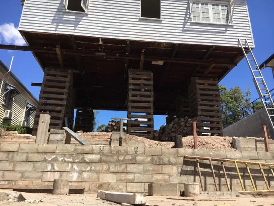 Home held on temporary timber cribbing during a house raise